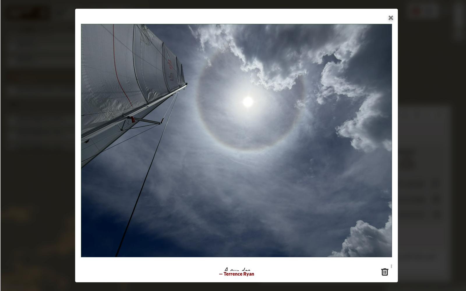 Photo modal showing a sailing photo with a caption field and delete button